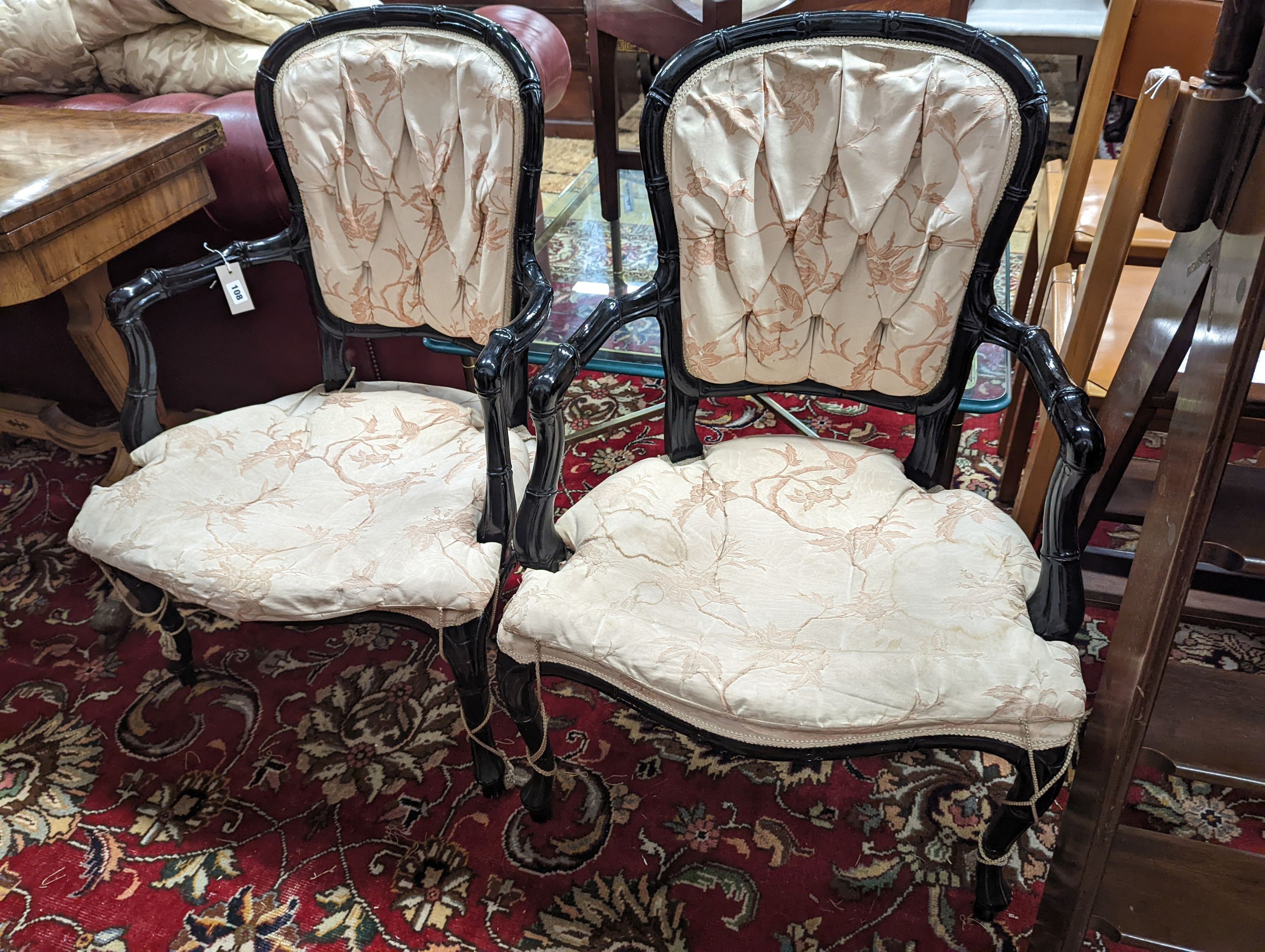 A pair of ebonised simulated bamboo open armchairs, width 59cm, depth 54cm, height 90cm